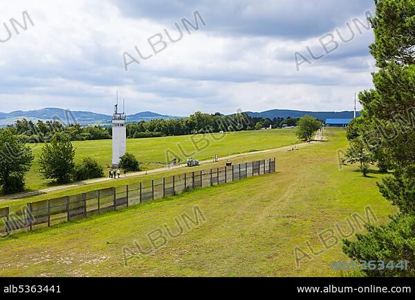 View from the US observation tower to the former border fortifications of the GDR with border tower, Kolonnenweg and fence, in the background the house on the border, Point Alpha, Hesse, Thuringia, Germany, Europe.