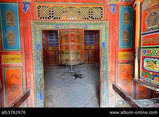 Tibetan Buddhism, wooden prayer wheel painted with Buddhist symbols, cylinder, at the kora, Labrang Monastery, Xiahe, Gansu, formerly Amdo, Tibet, China, Asia.