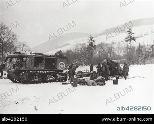 Men setting up a 8-inch howitzer, their target is a military barrack in Colmar.. Battle of Alsace, January-February 1945.