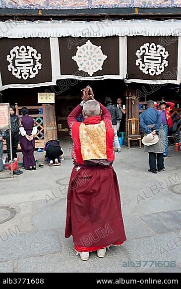 Tibetan Buddhist, monk praying in front of the Jokhang Temple, Barkhor Square, Lhasa, Himalayas, Tibet, China, Asia.