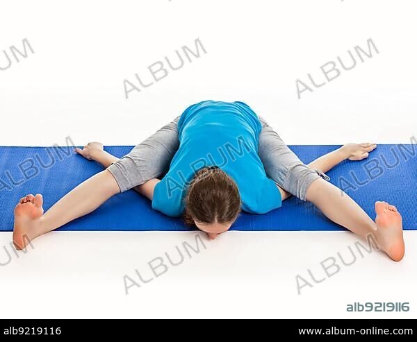 Sporty man practicing yoga. Kurmasana. Tortoise pose. Tortoise posture. Top  view Stock Photo | Adobe Stock