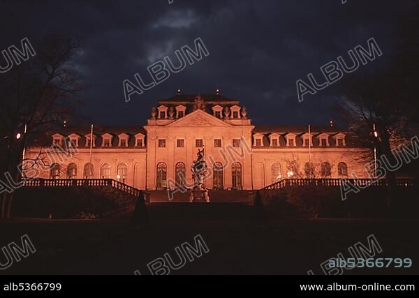 Fulda, Hessen: Orangerie in the garden of the castle in twilight , front: baroque figure Floravase made by Johann Friedrich Humbach , today the Orangerie is part of the hotel Maritim and used for special events.