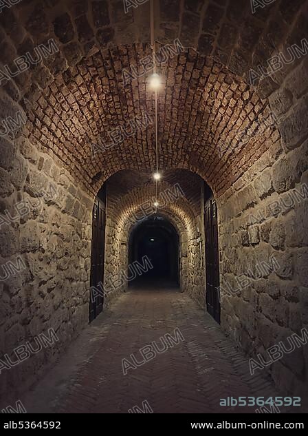 Old wine cellar tunnel at the Hincesti winery underground of the Manuc Bei mansion in Hancesti, Moldova. Traditional moldavian rural subterrane stone vault reconstructed with modern motif. Creepy dark details.