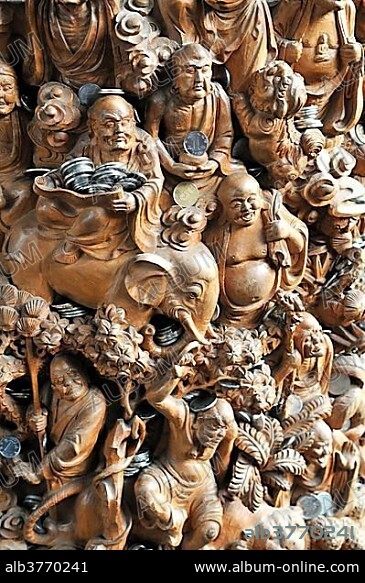 Carved Buddha sculptures with donated money, Jade Buddha Temple, Shanghai, China, Asia.