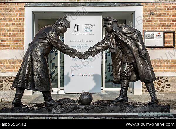 Statue by Andrew Edwards depicting British and German soldiers shaking hands during the Christmas truce in World War I, in front of the tourist information office in Mesen, Messines, West Flanders, Belgium, Europe.