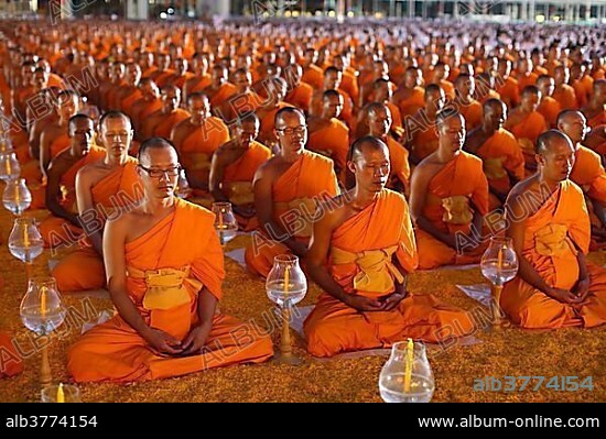 Monks sitting in a row meditating Wat Phra Dhammakaya Temple