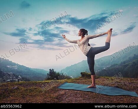 Woman practicing downward facing tree asana in yoga studio. Adho mukha  vrksasana pose Stock Photo
