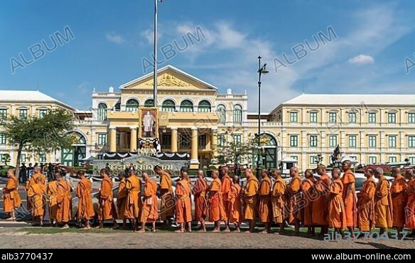 Row of monks in front of ministry of defense Bangkok Thailand