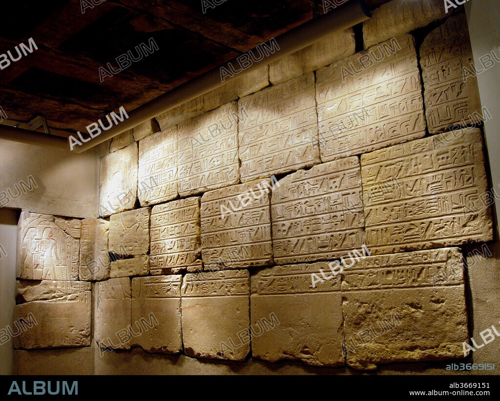 Burial chamber of Sobekmose. Dimensions: Dimensions of room: l. 315 cm (124 in); w. 219 cm. (86 1/4in); h. 222 cm. (87 3/8 in). Dynasty: Dynasty 18. Reign: reign of Amenhotep III. Date: ca. 1417-1379 B.C..
The burial chamber of Sobekmose, a treasury official under Amenhotpe III, is from el-Rizeiqat in Upper Egypt. Decorated burial chambers were not common in private tombs of Dynasty 18, and the scenes and texts usually distributed among several rooms in contemporary tombs are condensed here into a single chamber. The ceiling blocks, south wall, and partially preserved east entrance wall are the parts of the sandstone lining of the tomb installed here. The ceiling's inscriptions include a prayer to the sky goddess, Nut, recitations by Isis and Nut, and standard formulae claiming that "the Osiris [the overseer of the House of Silver] Sobekmose" is "honored by" the Four Sons of Horus and various gods. The east entrance wall as reconstructed is decorated with protective texts and guardian figures of Anubis on the lintel, and scenes of ritual ablution are depicted on the door jambs. The long south wall shows a priest burning incense and pouring a libation, and the rest of the wall is taken up by seven prayers to numerous deities. The  north and west walls, now in the Museum of Fine Arts in Boston (MFA 54.648), depict Sobekmose's funeral procession and his presentation to the gods of the underworld-Osiris and Anubis. The texts include selections from Spells 1, 15, 125, 130, and 151 of the Book of the Dead, and Utterance 32 of the Pyramid Texts.