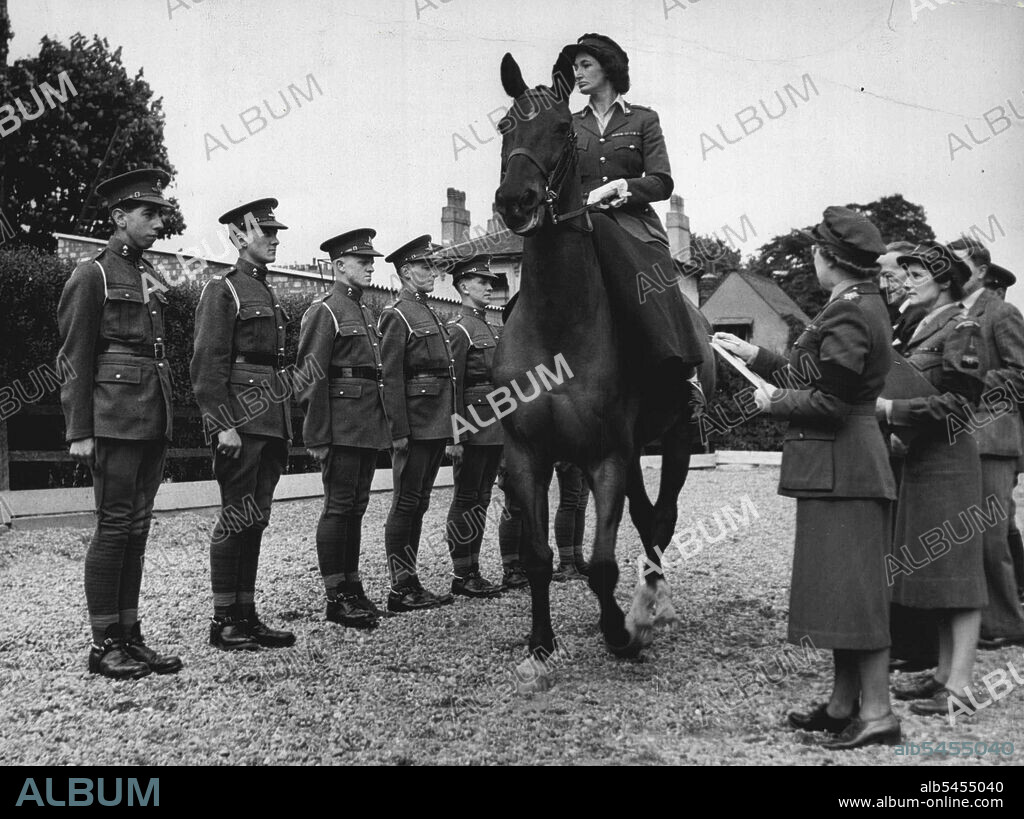 Service Girl As "Queen Elizabeth I" -- Lieut Col. M.I. Hewitt of 319 (West Lancs) Bn W.R.A.C. one of the three girls chosen from the W.R.A.C. at St. John's Wood Barracks, rehearsing the inspection of troops. By agreement with the Directors of the three women's Services - the W.R.N.S., W.R.A.C. and W.R.A.F. - a girl is to be chosen from their ranks to take part of "Queen Elizabeth I" at the Searchlight Tattoo at the White City in Huly.Three girls will be chosen from each of the three Services - from which 1 girl will be cohosen to represent "Queen Elizabeth I". May 20, 1952.