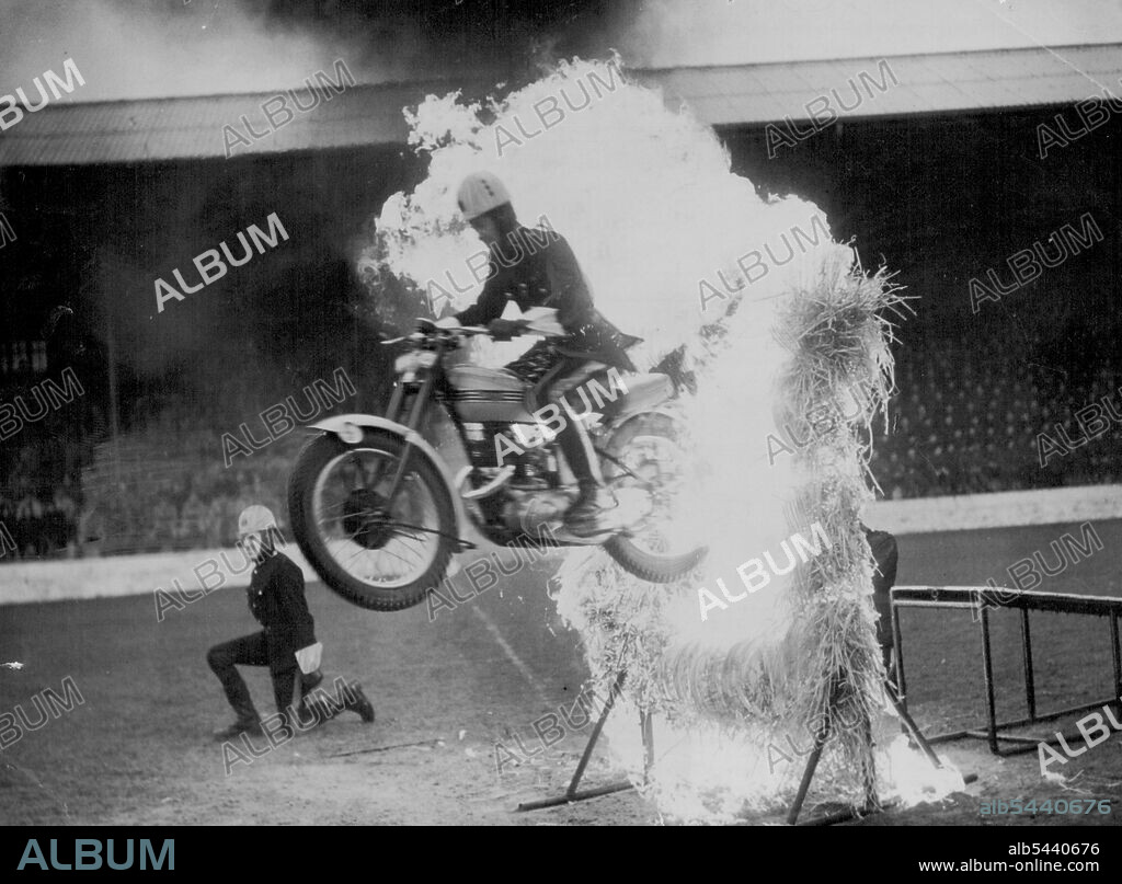 Fire Flyer - Spectators may get ***** under the collar, but this daring Army motor cyclist is perfectly cool as he makes a spectacular flight through a barrier of roaring flame. He is a member of the Royal Signals Motor-cycle. Display team and is pictured during a dress rehearsal at Catterick Camp, Yorkshire. The team will be seen at the northern Command Tattoo, taking place from June 28 to July 3 in Roundhay Park Leeds, Yorkshire. May 08, 1954. (Photo by Reuterphoto).