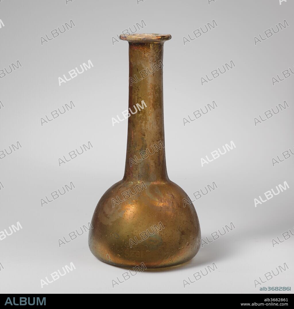 Glass perfume bottle. Culture: Roman. Dimensions: 5 1/4in. (13.3cm)
Other: 2 5/8in. (6.7cm)
Diam. of rim: 1 1/4 in. (3.1 cm). Date: 2nd-3rd century A.D..
Colorless with greenish tinge.
Rim folded out, over, and in, flattened on top; cylindrical neck expanding downward; bulbous body with convex sides; slightly concave bottom.
Intact; many bubbles; pitting, weathering, and brilliant iridescence.