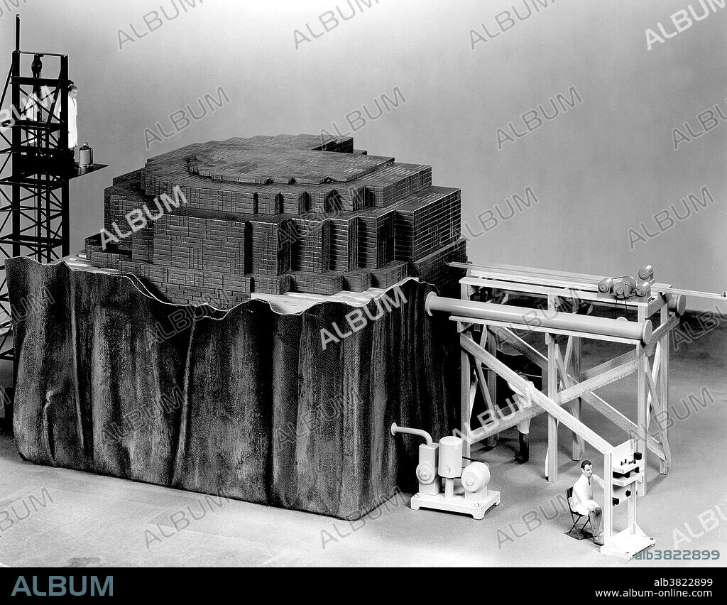 Closeup of scale model (1/2 in. = 1 ft.) of CP-1 reactor temporarily removed from its West Stands racquets court environment. Chicago Pile-1 (CP-1) was the world's first artificial nuclear reactor. The construction of CP-1 was part of the Manhattan Project, and was carried out by the Metallurgical Laboratory at the University of Chicago. It was built under the west viewing stands of the original Stagg Field. The first man-made self-sustaining nuclear chain reaction was initiated in CP-1 on December 2, 1942, under the supervision of Enrico Fermi. Fermi described the apparatus as "a crude pile of black bricks and wooden timbers." It was made of a large amount of graphite and uranium, with "control rods" of cadmium, indium, and silver, and unlike most subsequent reactors, it had no radiation shield or cooling system. Upon completion of the experiment, a coded message was transmitted to President Roosevelt: "The Italian navigator has landed in the new world.".