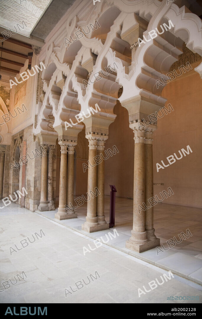 The Aljaferia Palace is a fortified palace that was built during the second half of the 11th century in Zaragoza by Abu Jafar Ahmad ibn Sulayman al Muqtadir billah (1046/7-1081/82), as the residence of the Banu Hud dynasty. It was originally named "Dar al Surur" ("House of Joy"). The name Aljaferia derives from "al-Jafariyya", after the name of its founder. The structure holds unique importance in that it is the only conserved testimony of a large building of Spanish Islamic architecture in the era of the Taifas (independent Islamic kingdoms). The most remarkable feature of the Aljaferia is in the systems of interlacing arches with a high degree of complexity. In 2001 Aljaferia Palace was added to the category of Mudejar Architecture of Aragon, that was declared World Heritage by UNESCO.