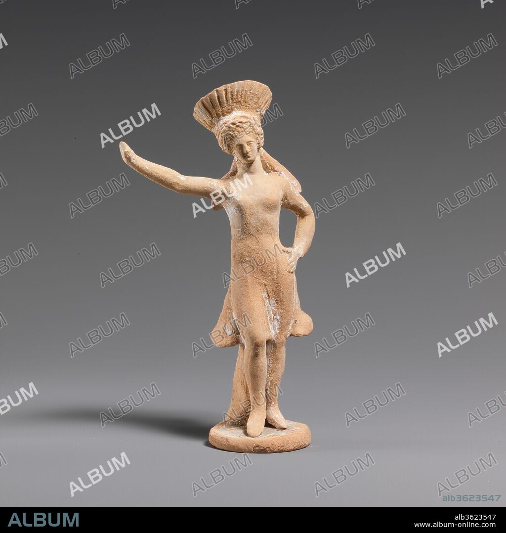 Terracotta statuette of a dancing girl. Culture: Greek, Corinthian. Dimensions: H. 4 15/16 in. (12.5 cm). Date: 4th century B.C..
Female dancer, toes touching base, propped up by support in back. Right foot advanced, right arm raised, left hand on hip. Wearing a flaring, striped headdress (a kalathiskos) with two fillets falling to shoulders in back. Garment is a knee length chiton. Red stripe on right leg suggests boots. Round, flat base.