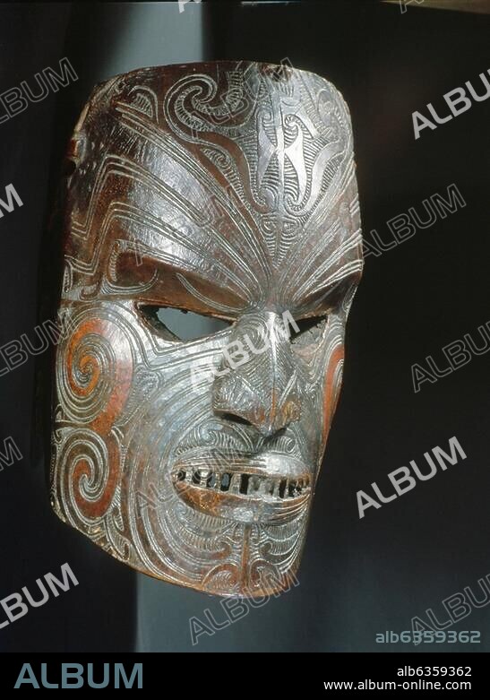 A carved hardwood mask with pierced eyes and mouth. The mask depicts aspecific ancestor who can be recognised by his distinctive pattern of moko facial tattoos. Country of Origin: New Zealand. Culture: Maori. Material Size: Wood.