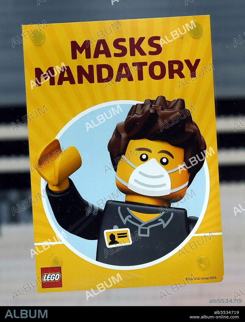 A sign ask patrons to continue wearing masks at the Lego store in