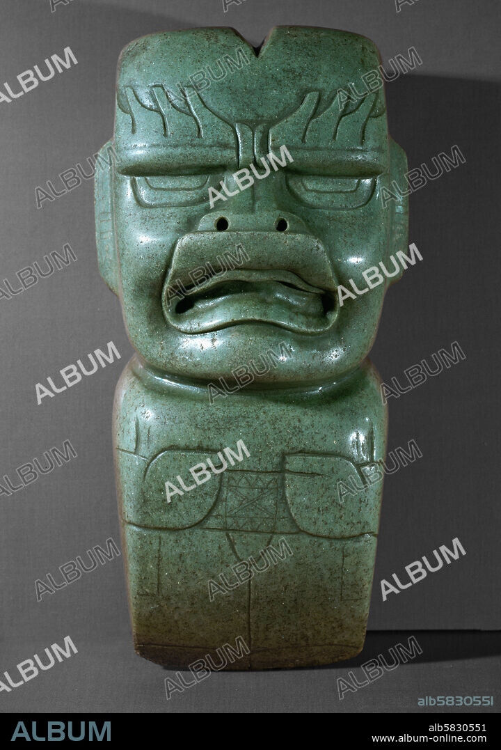 Ceremonial adze, representing the Olmec " God I" with his typical flaming eyebrows. Olmec art was a major influence on early Maya art. Green jadeite (1200-800 BCE). Height 29.5 cm. Inv. St. 536.