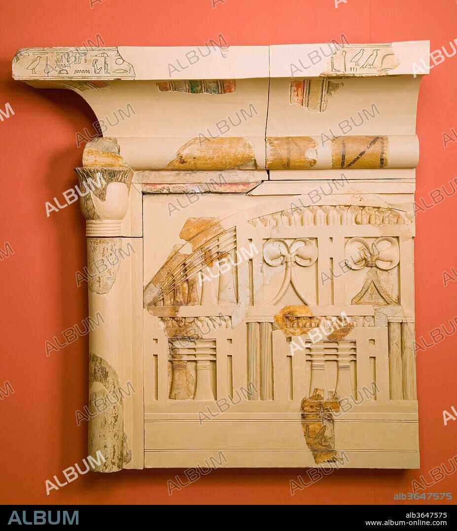 Part of the shrine of Queen Henhenet. Dimensions: H. 120 cm (47 1/4 in.); W. 114 cm (44 7/8 in.); D. 34 cm (13 3/8 in.). Dynasty: Dynasty 11. Reign: early reign of Mentuhotep II. Date: ca. 2051-2030 B.C..
The funerary complex of King Mentuhotep II at Deir el-Bahri is one of the most important monuments in the Theban area. Built between around 2050-2000 B.C., before the more famous Temple of Hatshepsut directly to its north, it lies in a remote desert valley within a bay of spectacular limestone cliffs.  The monument served multiple functions:  it was a mortuary complex for the king and female members of his family; a place of commemoration for Mentuhotep II's achievements as military and spiritual leader in the reunification of Egypt; and a sanctuary of the solar deity Montu, the Upper Egyptian counterpart to Re of Heliopolis.
Inside the temple precinct, in addition to both a burial place and a cenotaph for the king himself, were a number of tombs for royal women. The reconstruction here, a modern restoration incorporating ancient fragments, comes from the mortuary monument of Queen Henenet, one of six minor royal wives buried in shafts below the pavement of the temple's inner courtyard. These royal females, the youngest of whom was only about five, also served as priestesses to the goddess Hathor. Above each burial shaft was a limestone shrine built to imitate wooden architecture.