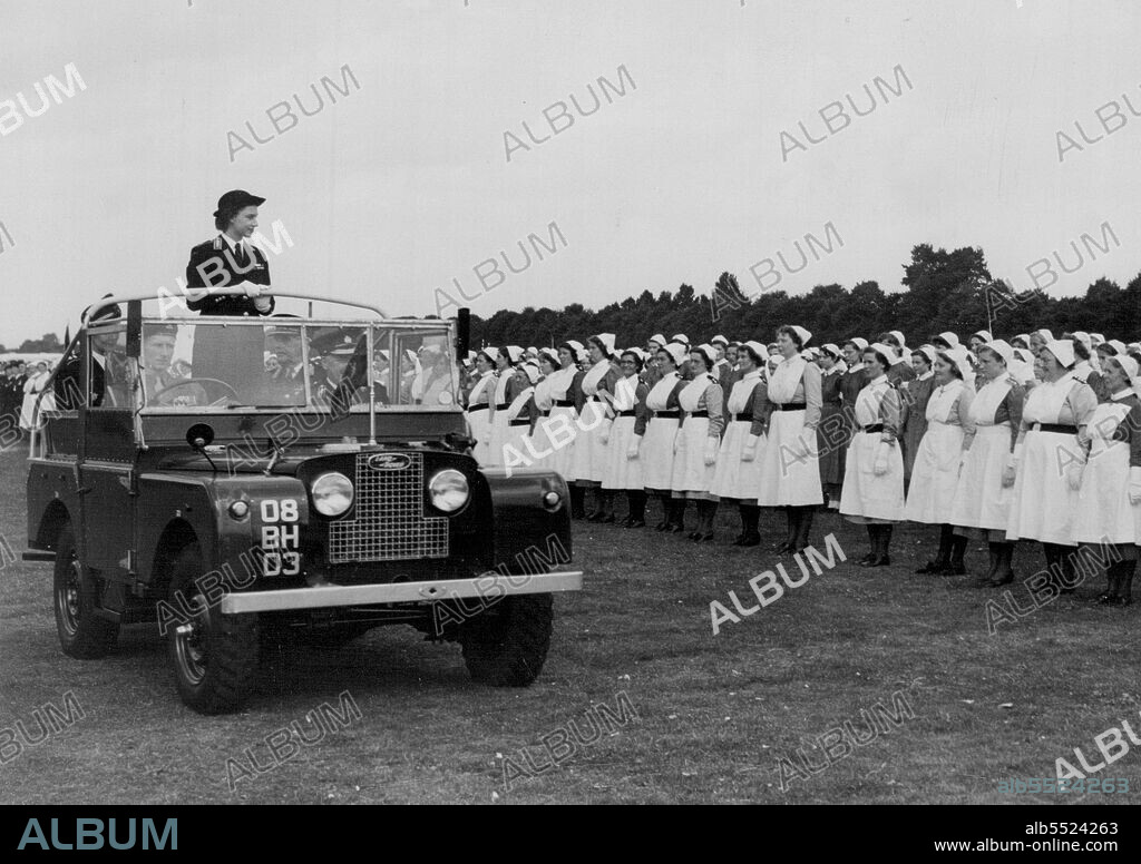 The Commandant Princess Inspects Her Cadets -- Princess Margaret, wearing her St. John Ambulance Brigade uniform, rides in a jeep as she inspects 3,000 cadets at a rally held on Woreaster race course. The Princess is commandant-in-chief of the St. John Ambulance Brigade, and the cadets who attended the rally had come from all parts of the world. July 26, 1952. (Photo by Plant News Ltd.).