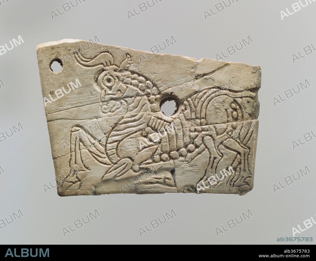 Incised furniture plaque with a kneeling bull. Culture: Assyrian. Dimensions: 1.54 x 2.13 x 0.16 in. (3.91 x 5.41 x 0.41 cm). Date: ca. 9th-8th century B.C..
This trapezoidal plaque was found in a room that has been identified as part of the royal residency at Fort Shalmaneser, a royal building at Nimrud that was probably used to store tribute and booty collected by the Assyrians while on military campaign. Ivories with incised decoration like this one have been attributed to an Assyrian style similar to the large reliefs lining the walls of the Northwest Palace. The kneeling bull depicted on this plaque, with its stylized musculature and elaborately incised anatomy, recalls the animals embroidered on the robes worn by the figures in the palace reliefs and can be compared with depictions of animals in glyptic art and glazed ceramics from the Neo-Assyrian period. Two dowel holes that pierce the plaque were probably used to fasten it to a frame or other backing that does not survive. At Nimrud, Assyrian style ivories have been found in royal areas such as throne rooms and ceremonial or royal residential suites. The limited distribution of Assyrian ivories could suggest that their use and display was highly restricted.
Built by the Assyrian king Ashurnasirpal II, the palaces and storerooms of Nimrud housed thousands of pieces of carved ivory. Most of the ivories served as furniture inlays or small precious objects such as boxes. While some of them were carved in the same style as the large Assyrian reliefs lining the walls of the Northwest Palace, the majority of the ivories display images and styles related to the arts of North Syria and the Phoenician city-states. Phoenician style ivories are distinguished by their use of imagery related to Egyptian art, such as sphinxes and figures wearing pharaonic crowns, and the use of elaborate carving techniques such as openwork and colored glass inlay. North Syrian style ivories tend to depict stockier figures in more dynamic compositions, carved as solid plaques with fewer added decorative elements. However, some pieces do not fit easily into any of these three styles. Most of the ivories were probably collected by the Assyrian kings as tribute from vassal states, and as booty from conquered enemies, while some may have been manufactured in workshops at Nimrud. The ivory tusks that provided the raw material for these objects were almost certainly from African elephants, imported from lands south of Egypt, although elephants did inhabit several river valleys in Syria until they were hunted to extinction by the end of the eighth century B.C.