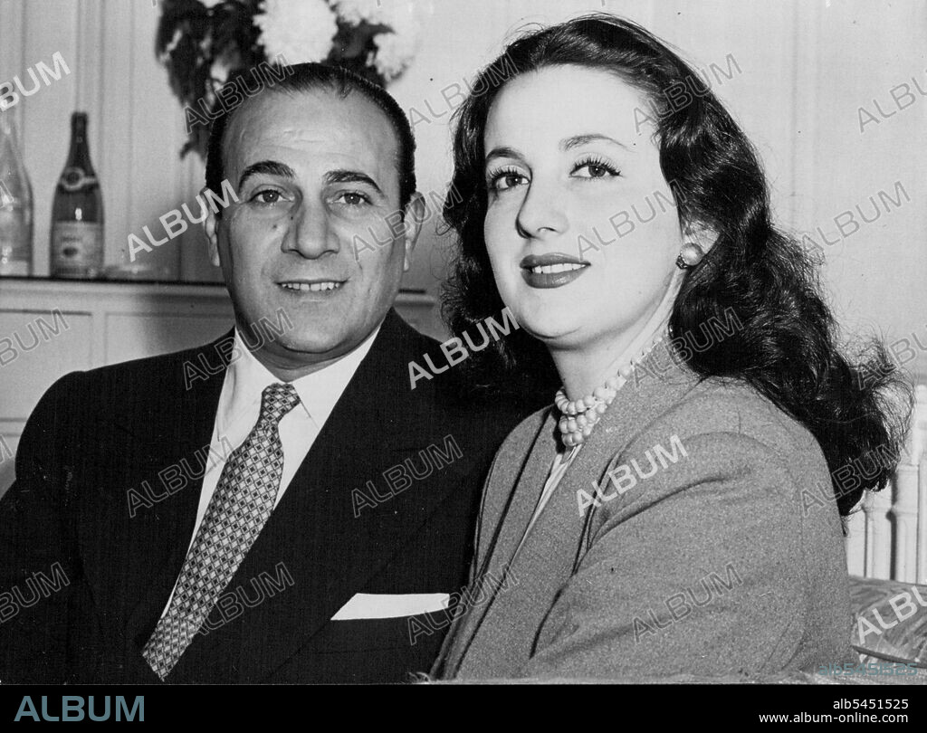 Rossi to Sing in London -- Tino Rossi and his wife Lilia seen together in the Savoy Hotel, London, today.
Satisfying sight for corsica-born singer Tino Rossi and his wife Lilia is the Skyline of London, seen from a balcony of the Savoy Hotel, London. Rossi, internationally famous singer in both English and French, will perform in London for the first time, at the Piccadilly Theatre (October 16 to 28). His wife is the French Film Actress Lilia Vitte. They have been married there years and have a two year-old boy, Laurenz. October 15, 1950. (Photo by John Trievnor, Paul Popper Ltd.).