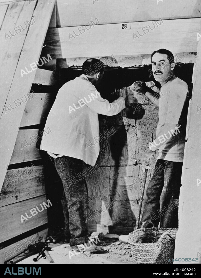 Howard Carter and a colleague excavating a tomb in the Valley of