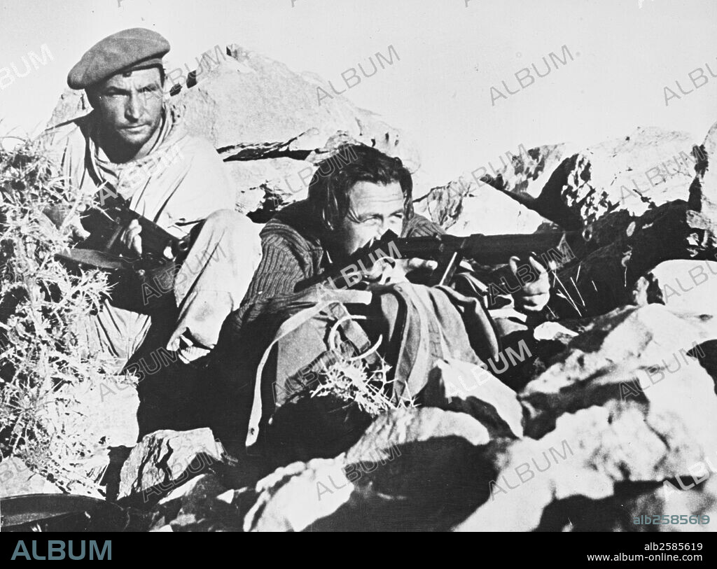 Liberation british and Greek forces.Two soldiers,members of a small body of specially trained British and Greek troops fighting the Germans in the Aegean Islands, cover an enemy garrison o nteh Island of Symi while their comrades creep forward in July,44.