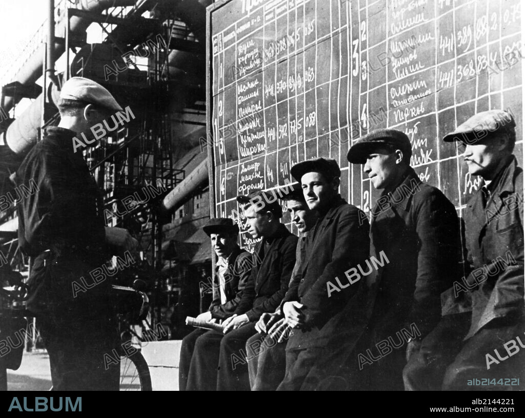 Workers studying diagrams indicating the output accomplished at the blast furnace shop of the magnitogorsk iron and steel works. 01/02/2013