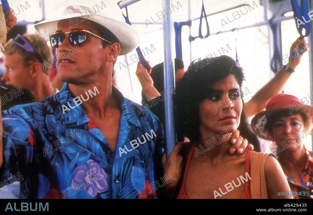 ARNOLD SCHWARZENEGGER and MARIA CONCHITA ALONSO in THE RUNNING MAN, 1987, directed by PAUL MICHAEL GLASER. Copyright TRI STAR PICTURES.