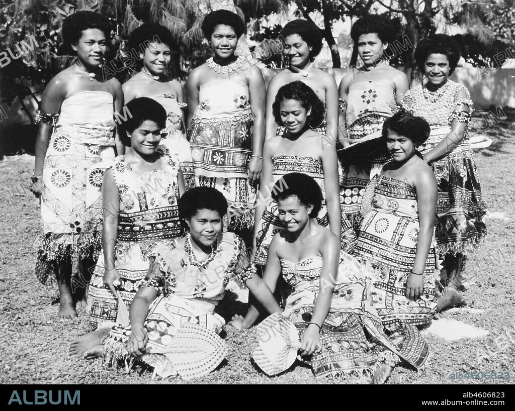 Fiji, Fijian women wearing 'masi' clothA group of Fijian women pose for a portrait, wearing printed 'masi' (bark cloth) costumes. Caption reads: A happy group in Nasilai, 1965. 2005/010/1/14/90.