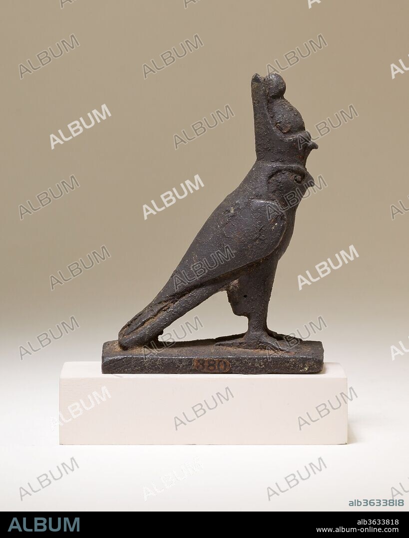 Horus falcon figure. Dimensions: H. 8.2 cm (3 1/4 in.); W. 2.5 cm (1 in.); L. 6.3 cm (2 1/2 in.). Date: 664-30 B.C..
The falcon god Horus stands with his wings swept back. He wears the double crown of Egypt, a royal crown that symbolizes the union of Lower and Upper Egypt, and highlights Horus' role as the legitimate ruler of the entire land. The falcon wears the double crown because Horus and the concept of kingship were closely tied, as early as the Predynastic Period. 
The falcon stands on a rectangular platform, which could have functioned in a number of ways. The figure could have been attached to a separate cupreous metal or wooden base, or it could have topped a standard modeled after those used in festival processions and on sacred barks. The falcon also could have sat on top of a hollow box intended for holding an animal mummy, like 41.160.107. Such falcon mummy boxes, or sarcophagi, would have been offered for deposition in animal necropoleis, not just in relation to the cult of Horus, but also more broadly in association with solar cult.