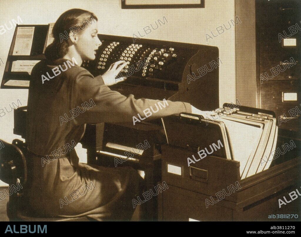 From the early 1900s through the 1960s, mechanical calculators dominated the desktop computing market. These devices were motor-driven, and had movable carriages where results of calculations were displayed by dials. Nearly all keyboards were full - each digit that could be entered had its own column of nine keys, 1 thru 9, plus a column-clear key, permitting entry of several digits at once. In these machines, addition and subtraction were performed in a single operation, as on a conventional adding machine, but multiplication and division were accomplished by repeated mechanical additions and subtractions. Bulky calculating machines like this one were essential office tools in the days before the digital revolution. Here a busy accounts clerk refers to a drawerful of files as she punches in figures at the console. No photographer credited, undated.