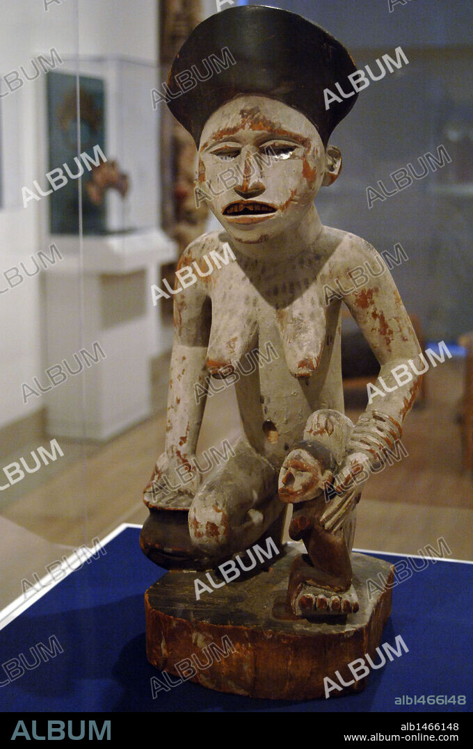 Kneeling female figure with bowl and child. Late 19th or early 20th century. Kongo peoples, Yombe group. Wood, kaolin, glass or mica and pigment. Democratic Republic of the Congo. Africa. Dallas Museum of Art. State of Texas. United States.