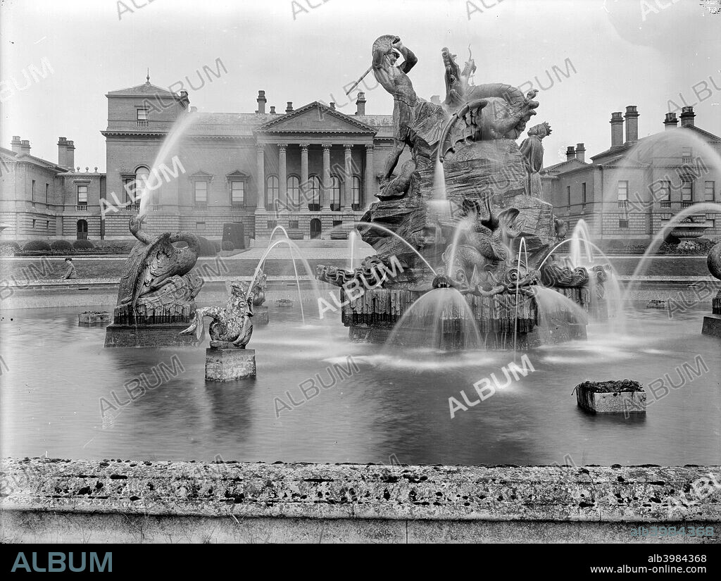 A fountain with sculpture depicting Perseus and Andromeda at Holkham Hall, Norfolk, February, 1929. The fountain was designed by Charles R Smith circa 1850. The statuary is constructed in limestone and set in a circular pond.