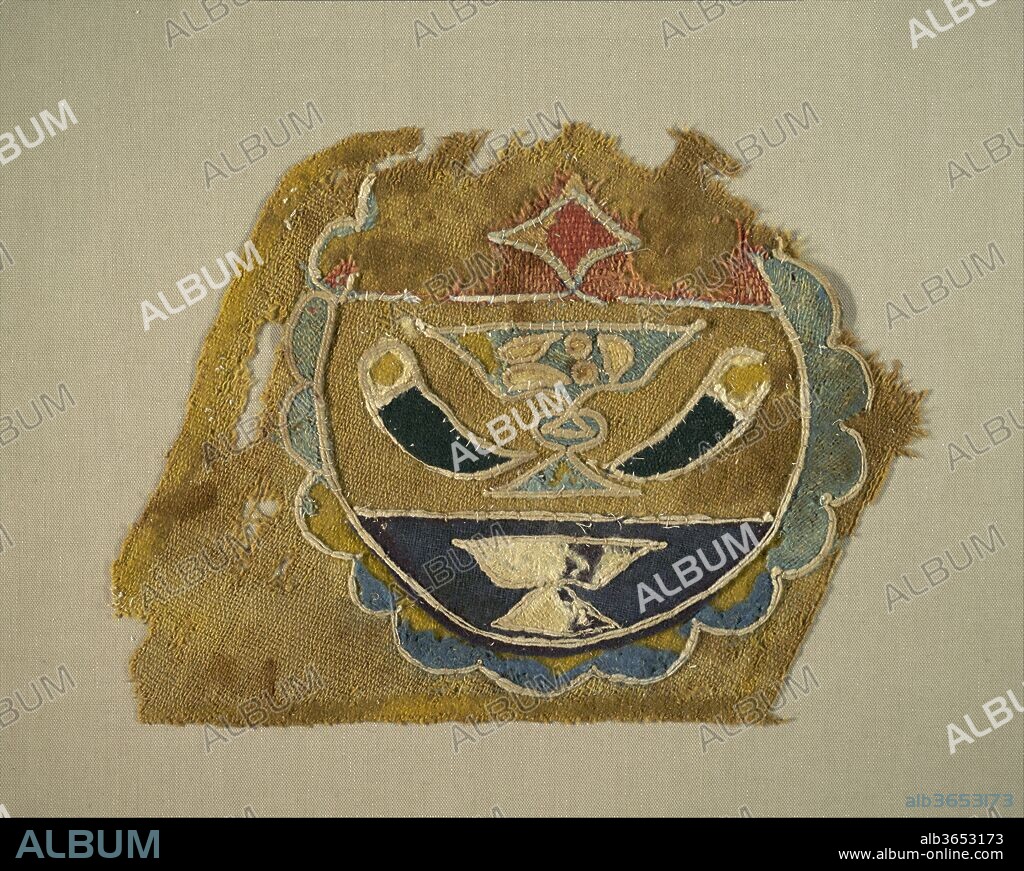 Textile Fragment with Mamluk Emblem. Dimensions: H. 9 in. (22.9 cm)
W. 12 in. (30.5 cm). Date: late 15th-early 16th century.
The Mamluks developed a system of emblems or blazons to signify the role of courtiers serving under each sultan. This emblem dates to the reign of Sultan al-Ashraf Qaitbey (r. 1468-96) or of one of his successors, and is likely a fragment from an article of clothing or a piece of furniture. Numerous Venetian Renaissance paintings, including The Reception of the Venetian Ambassadors in Damascus, incorporate strikingly similar Mamluk emblems in their compositions.