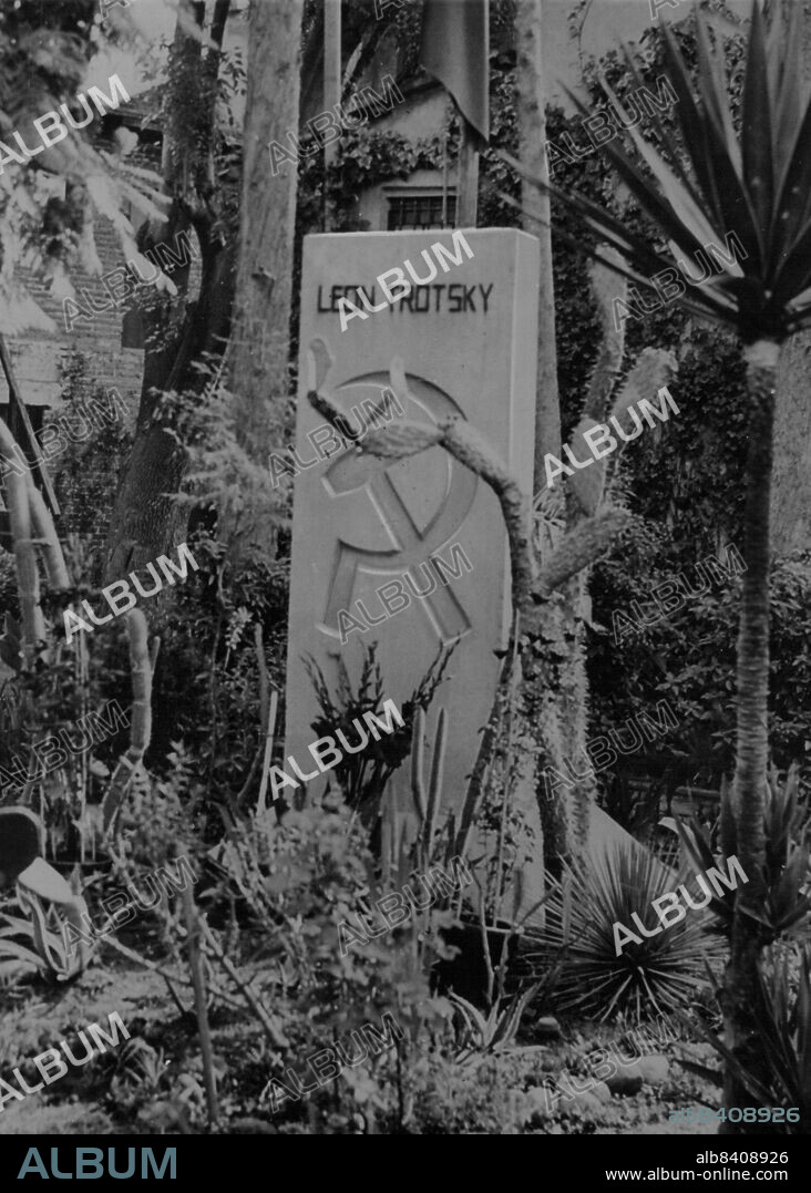 This is the tomb stone over the grave of the old Bolshevik, Leon trotsky. It is in the patio of the house in which he was slain in Mexico City.Trotsky's grave, with the sign of the hammer and sickle, is among the cactus of his garden. November 17, 1954.