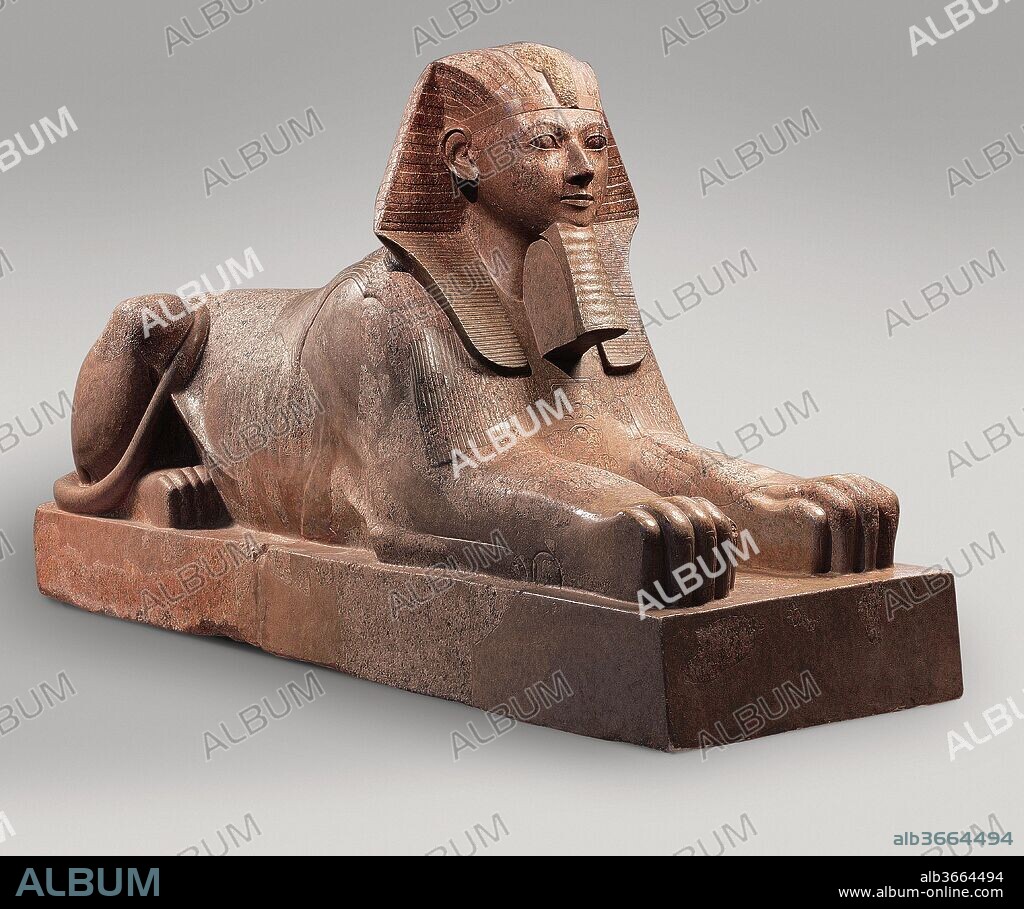 Sphinx of Hatshepsut. Dimensions: H: 164 cm (64 9/16 in.); L: 343 cm (135 1/16 in.); Wt: 6758.6 kg (14900  lb.). Dynasty: Dynasty 18. Reign: Joint reign of Hatshepsut and Thutmose III. Date: ca. 1479-1458 B.C..
This colossal sphinx portrays the female pharaoh Hatshepsut with the body of a lion and a human head wearing a nemes headcloth and royal beard.  The sculptor has carefully observed the powerful muscles of the lion as contrasted to the handsome, idealized face of the pharaoh. It was one of at least six granite sphinxes that stood in Hatshepsut's mortuary temple at Deir el-Bahri.  Smashed into many fragments at the order of Hatshepsut's nephew and successor Thutmose III and dumped in a quarry close by, this beast was recovered by the Museum's Egyptian Expedition and reassembled. It weighs more than seven tons.
Part of a second sphinx of Hatshepsut (31.3.164) is on display in gallery 115. The sphinx has a long history in Egyptian art, the most famous example being the great sphinx at Giza which represents the Fourth Dynasty King Khafre who lived almost a thousand years before Hatshsepsut. Sphinxes representing other pharaohs may be seen throughout the Egyptian galleries.