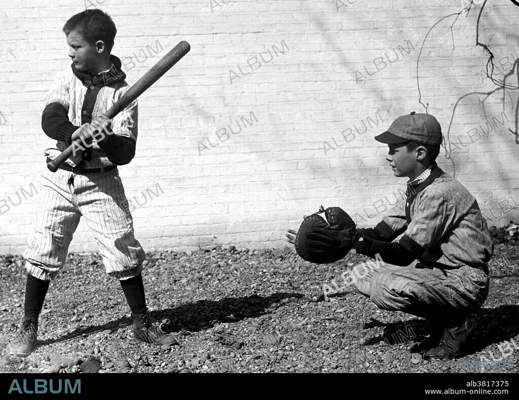 Entitled: "Boys playing baseball." Baseball is a bat-and-ball game played between two teams of nine players each who take turns batting and fielding. Evolving from older bat-and-ball games, an early form of baseball was being played in England by the middle of the 18th century. This game was brought by immigrants to North America, where the modern version developed. By the late 19th century, baseball was widely recognized as the national sport of the United States. Baseball is now popular in North America and parts of Central and South America and the Caribbean, East Asia, and Europe. Photographed by the National Photo Company, March 21, 1923.