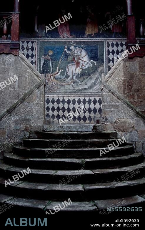 Valle d'Aosta (Aosta Valley, Piedmont, Italy, Castello Fénis (castle, built 1330, restored 1896 by Alfredo d'Andrale). Partial view: outdoor stairs in the inner courtyard with fresco of St. George fighting with the dragon (c. 1420). Photo, undat.