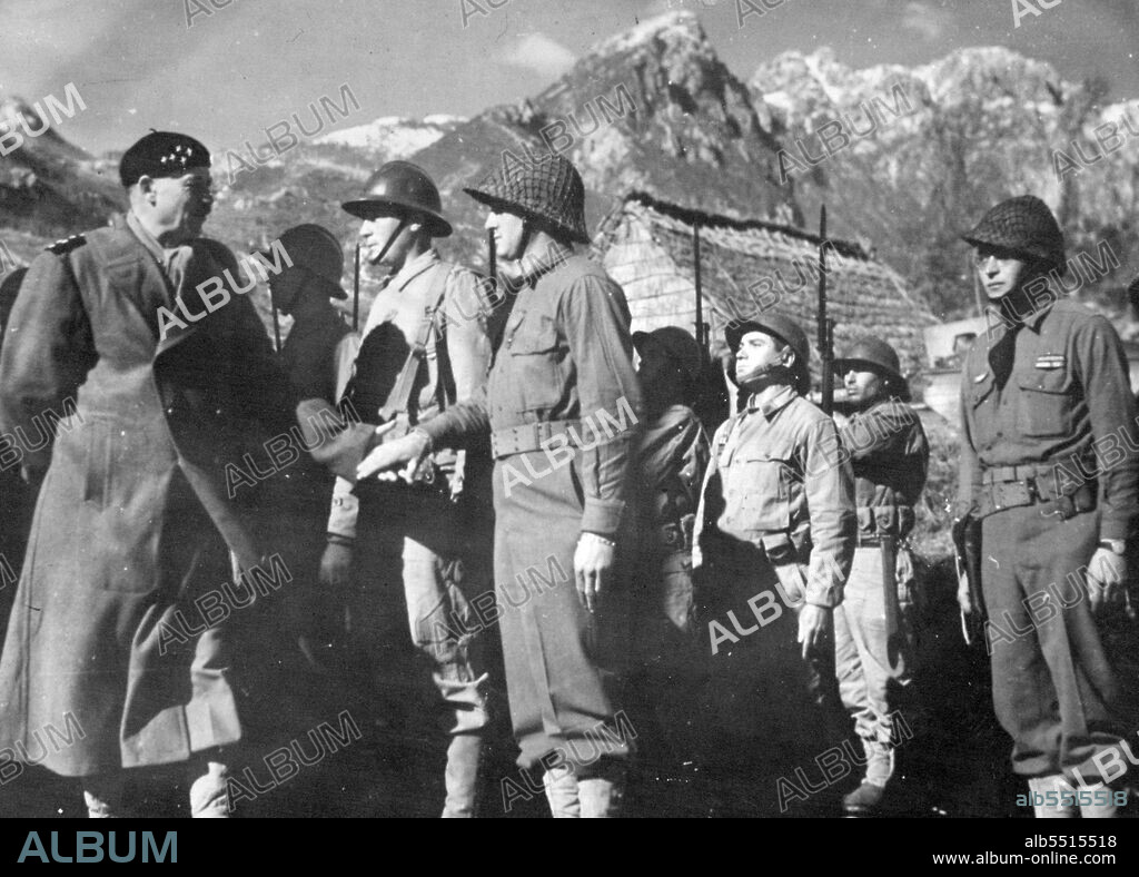 General Juin Visits French Troops On Italian Front 
General Alphonse-Pierre Juin (left), commander of the French Expeditionary Corps in Italy, reviews troops under his command, fighting with the Allied Fifth Army against the Germans, during an inspection tour of the Allied front in Western Italy. March 24, 1944.