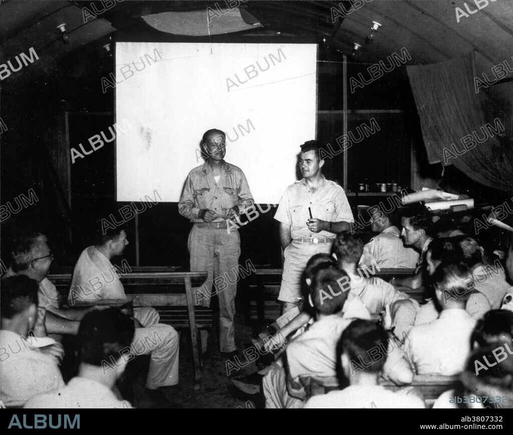 Hiroshima Bomb Crew. At the briefing prior to flight of the Enola Gay, Captain William Sterling Parsons and Colonel Tibbets go over last minute data. Both are members of the crew that dropped the first atomic bomb. Only Tibbetts, Ferebee, and Parsons, knew the purpose of the mission. On August 6, 1945, the Enola Gay was used to drop, from an altitude of 31,600 feet, the "Little Boy" atomic weapon, destroying Hiroshima, Japan, at 8:16 a.m. local time. The airplane was flown by Col. Paul Tibbets, commander of the 509th Group, and had a crew of 11. Days before the mission, Tibbets named the airplane "Enola Gay" in honor of his mother. Enola Gay returned safely to its base on Tinian to great fanfare. The Enola Gay was accompanied by two other B-29s, Necessary Evil which was used to carry scientific observers, and as a camera plane to photograph the explosion and effects of the bomb and The Great Artiste instrumented for blast measurement. Enola Gay is a Boeing B-29 Superfortress bomber.