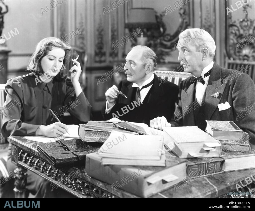 GRETA GARBO in NINOTCHKA, 1939, directed by ERNST LUBITSCH. Copyright M.G.M. RELEASE DATE: February 1, 1940. MOVIE TITLE: Ninotchka. STUDIO: Metro-Goldwyn-Mayer (MGM). PLOT: Only the royal suite at the grandest hotel in Paris has a safe large enough for the jewels of the Grand Duchess Swana. So the three Russians who have come to sell the jewels settle into the suite until a higher ranking official is dispatched to find out what is delaying the sale. She is Ninotchka, a no nonsense woman who fascinates Count Leon who had been the faithful retainer of the Grand Duchess. The Grand Duchess will give up all claim to the jewels if Ninotchka will fly away from the count. But can one count on a count? PICTURED: GRETA GARBO as Ninotchka.