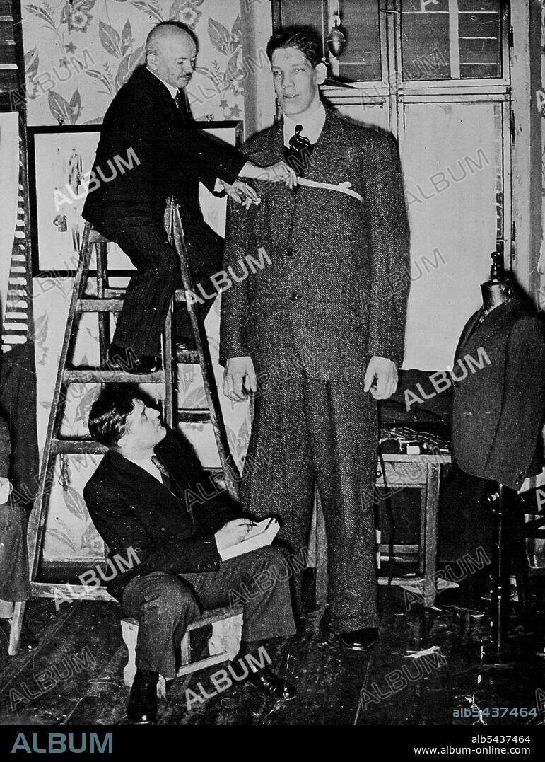 A Tall Order - Baine Myllyrinne, 8½ foot giant, being measured for a suit  in Vienna, where he is training to become a boxer. Believe it or not, Baine  Myllyrinne, eight and -