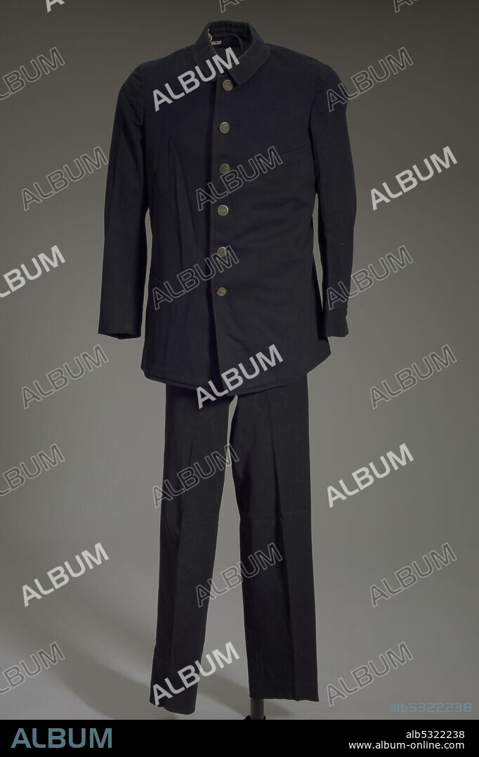 A Pullman Porter uniform jacket and trousers owned by Robert Jackson Thomas. Being a Pullman porter was one of the jobs that helped build the black middle class in America, and Pullman porters were key figures in the civil-rights movement. The jacket is made from a heavy wool-like material with a two inch collar and lined with a lighter black textured fabric. There are six metal outer buttons stamped with "PULLMAN" and six inner navy plastic buttons running down the opening of the coat. Each sleeve has two buttons on the cuff and a small square textile design on the wrist. The outside of the jacket has single-welt pockets on the left breast, on the right hip, and in the interior liner of the right breast. A sewn label directly under the interior pocket reads “Wanamaker & Brown / Philadelphia” in yellow thread on black fabric.