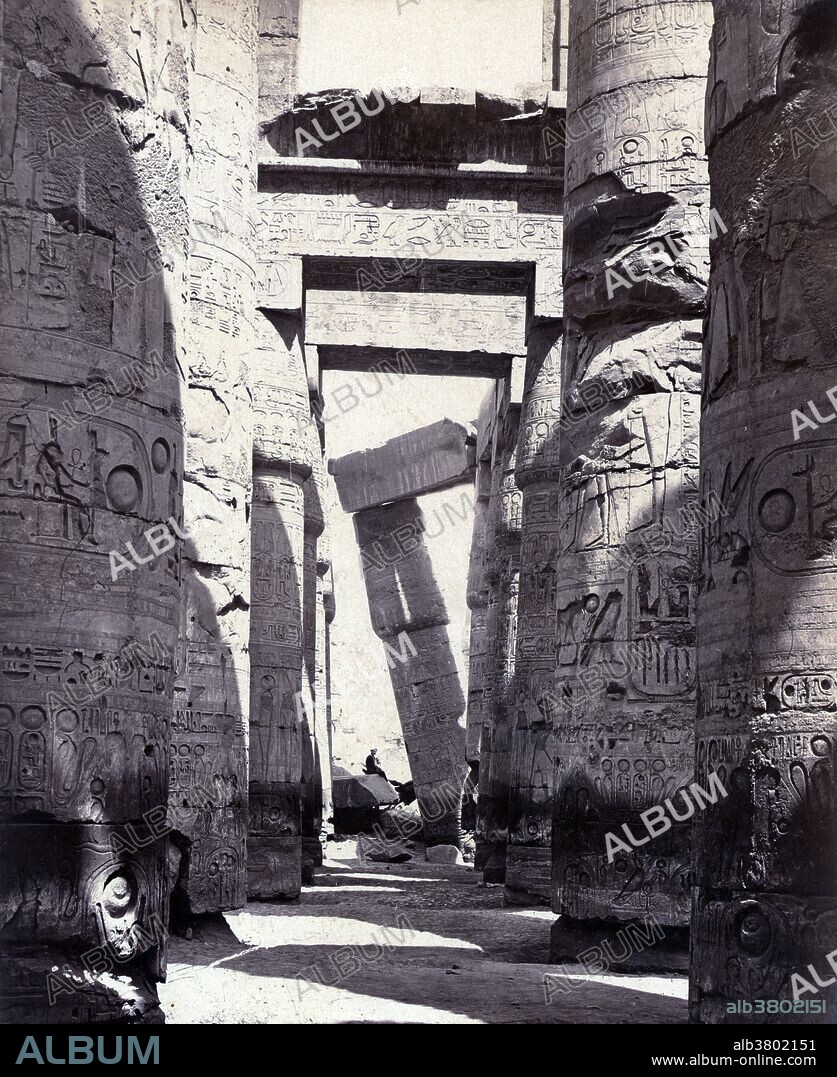 Columns of a hypostyle temple, Thebes, photographed by Maison Bonfils, circa 1867-1885. The Great Hypostyle Hall of Karnak, located within the Karnak temple complex, in the Precinct of Amon-Re, is one of the most visited monuments of Ancient Egypt. The Karnak Temple Complex comprises a vast mix of decayed temples, chapels, pylons, and other buildings. Building at the complex began during the reign of Senusret I in the Middle Kingdom and continued into the Ptolemaic period, although most of the extant buildings date from the New Kingdom. The area around Karnak was the ancient Egyptian Ipet-isut (The Most Selected of Places) and the main place of worship of the eighteenth dynasty Theban Triad with the god Amun as its head. It is part of the monumental city of Thebes. The complex is a vast open-air museum and the largest ancient religious site in the world. FÃ©lix Bonfils (March 8, 1831 - 1885) was a French photographer and writer who was active in the Middle East. He moved his family to Beirut in 1867 where they opened a photographic studio called "Maison Bonfils".