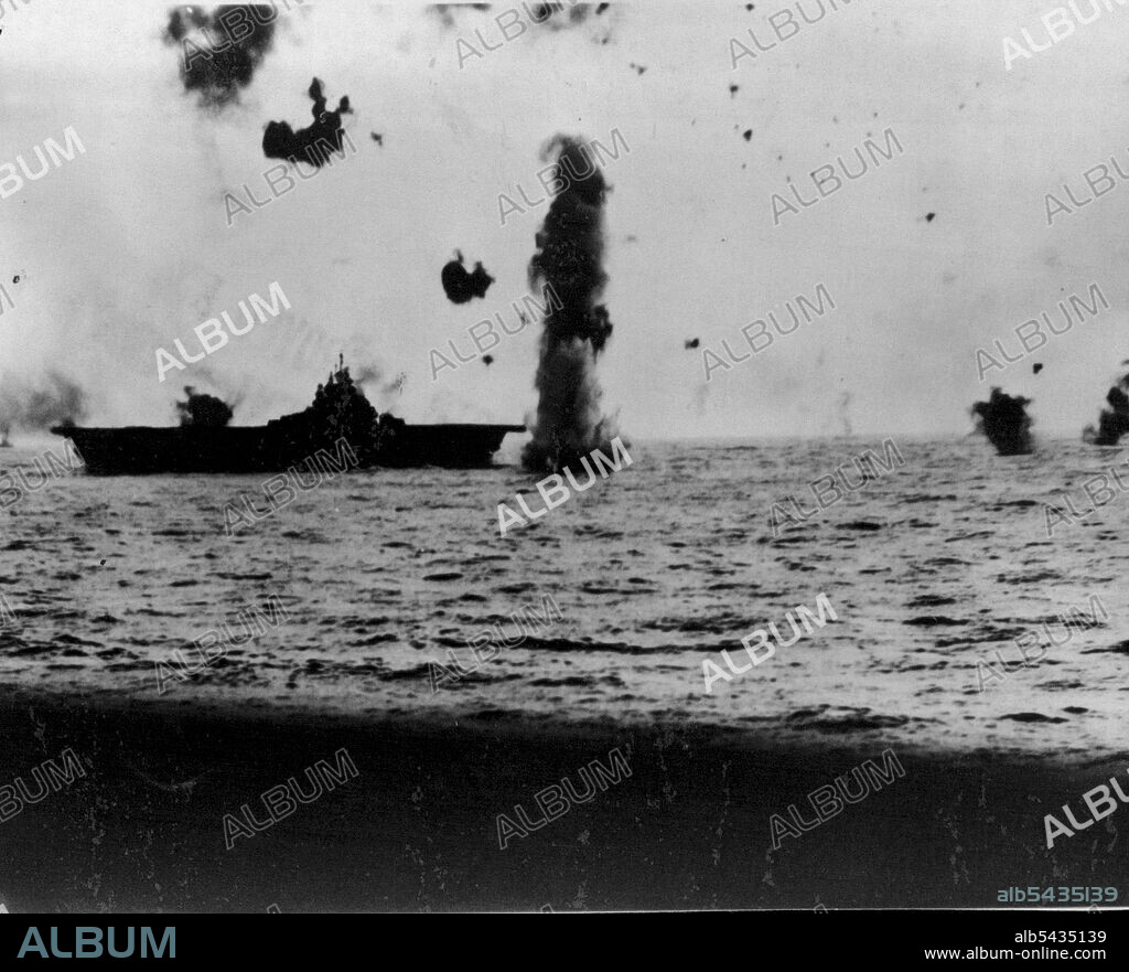 Suicide Dive In Vain -- A Japanese Kamikaze (Suicide Plane) attempting to crash-dive aboard an Essex-class carrier, one of the Navy's newest, ran into a heavy blanket of anti-aircraft fire which send it crashing into the sea, just missing the carrier bow. Action took place in the Pacific. June 15, 1945. (Photo by U.S. Navy).