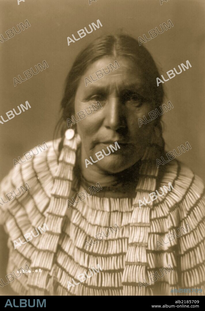 Hidatsa Indian woman posed, head and shoulders, facing front.