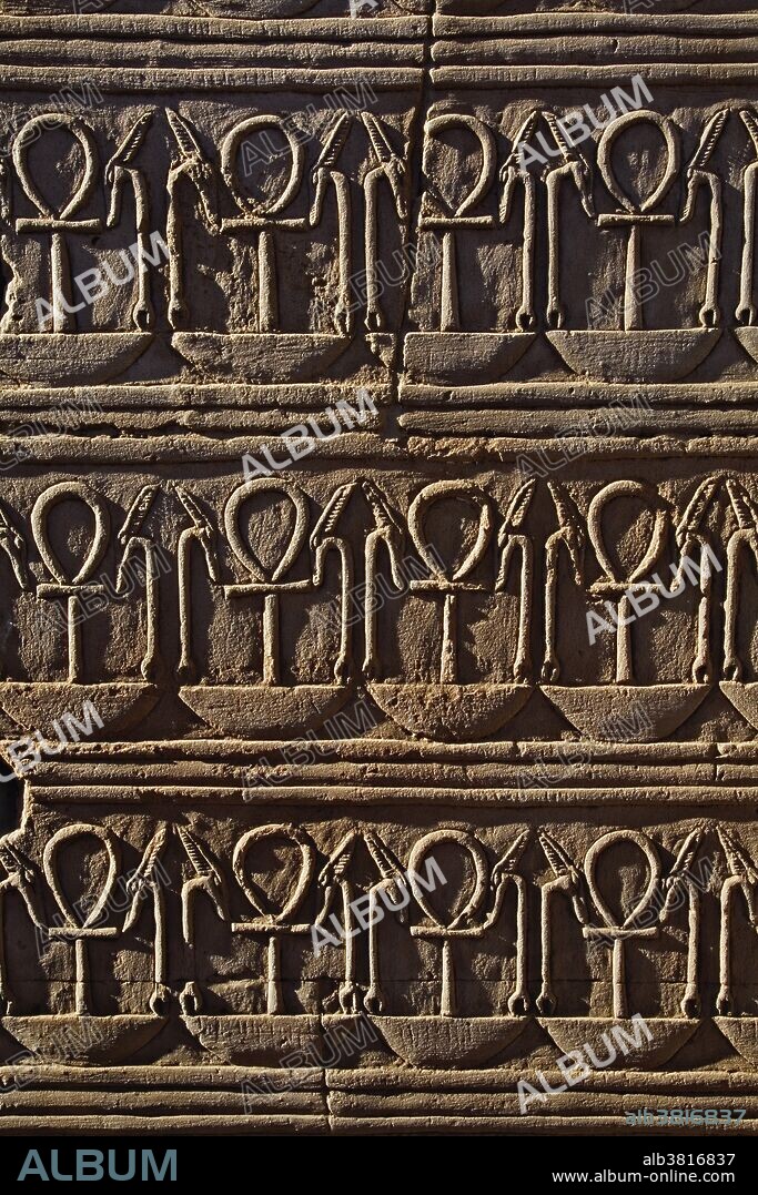 Coptic Christian symbol in hieroglyphs at the Temple of Kom-Ombo, near Aswan, Egypt. The temple, dedicated to both the crocodile god Sobek and the falcon god Haroeris (Horus), was built between 180 - 44 BC. The Coptic Christian symbol is considered one of the most widely recognized symbols other than the cross. It is a symbol for life or living.