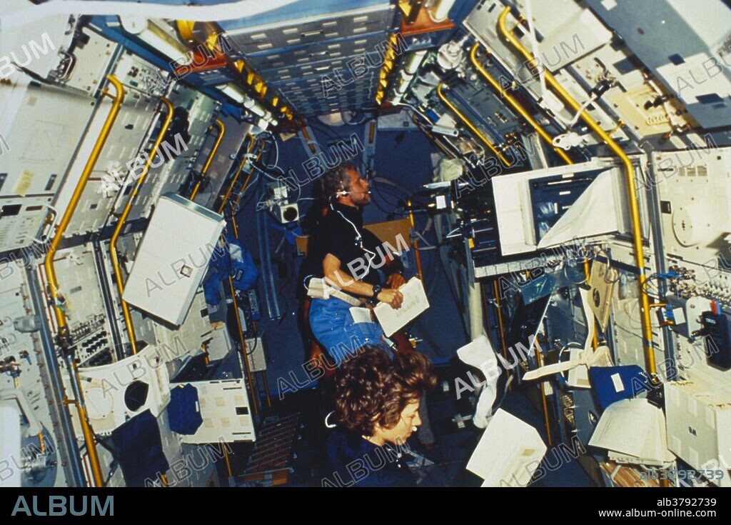 STS-61-A crew members Bonnie Dunbar and Guion Bluford onboard the Challenger space ship, at work on a physics experiment. The mission lasted from October 30, 1985 to November 6, 1985.